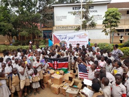 A group of people standing around boxes and signs.