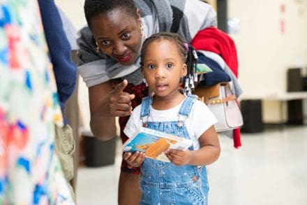 A woman and child are looking at something.