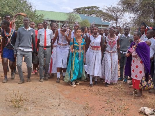 A group of people standing in front of some trees